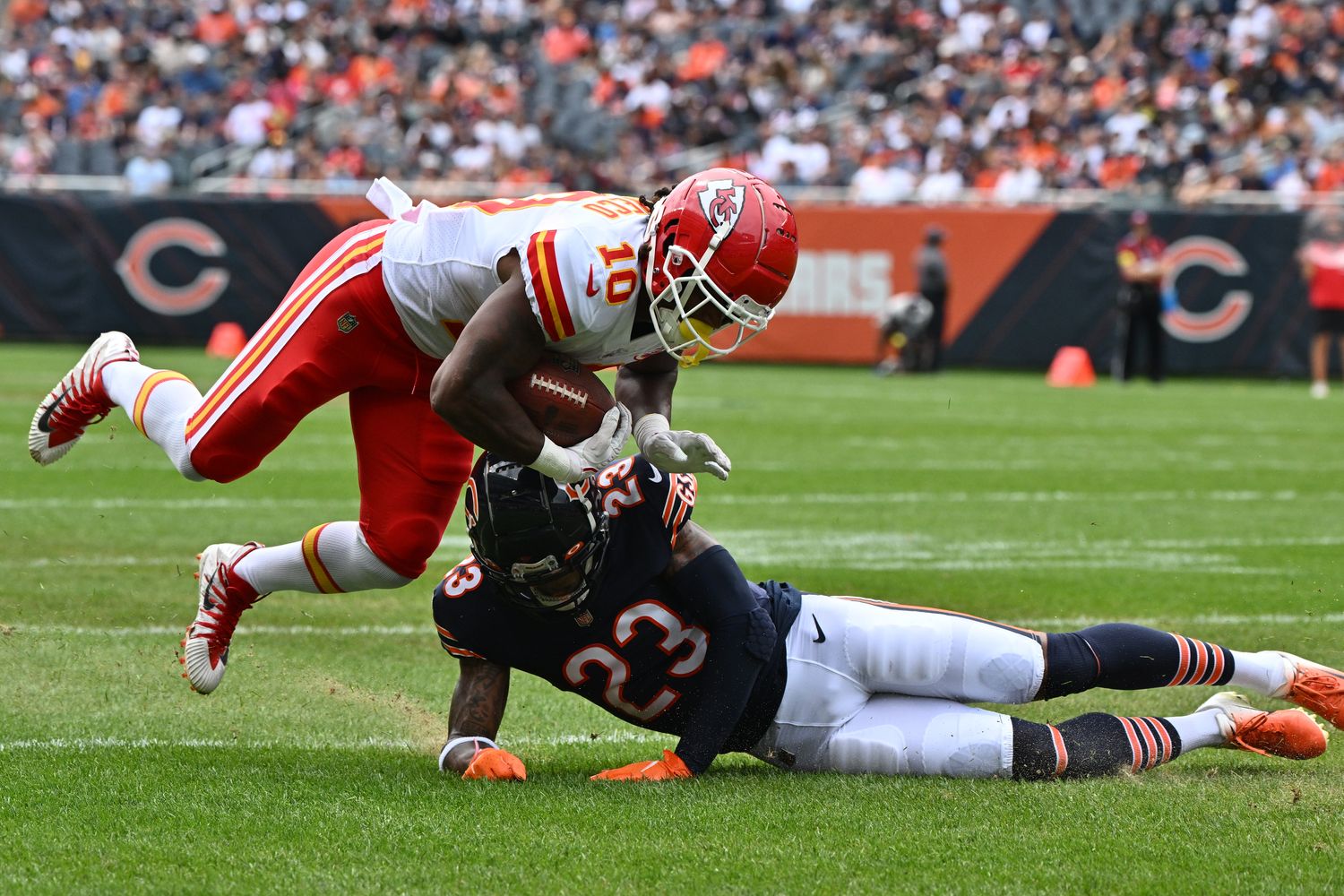 Aug 13, 2022; Chicago, Illinois, USA; Kansas City Chiefs running back Isiah Pacheco (10) is taken down by Chicago Bears defensive back Lamar Jackson (23) in the first quarter at Soldier Field. Mandatory Credit: Jamie Sabau-USA TODAY Sports